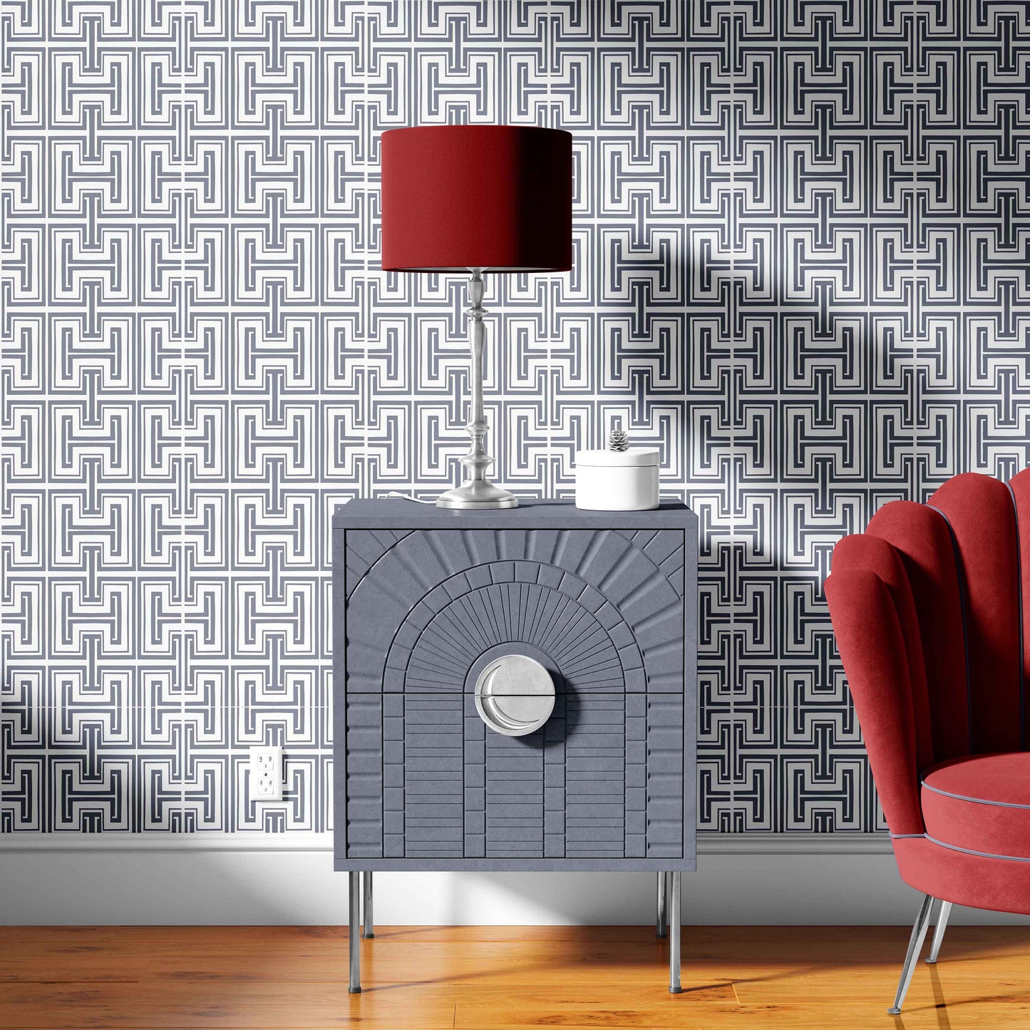 grey_Grey textured side table with red lamp and pink chair against geometric patterned wallpaper