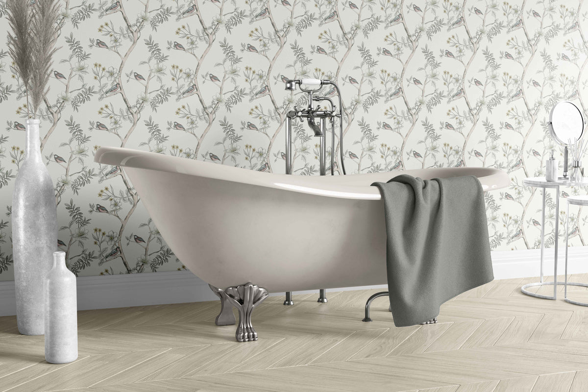 cream_A roll of wallpaper with a floral pattern featuring birds among the foliage, predominantly in pastel colors in a vintage bathroom