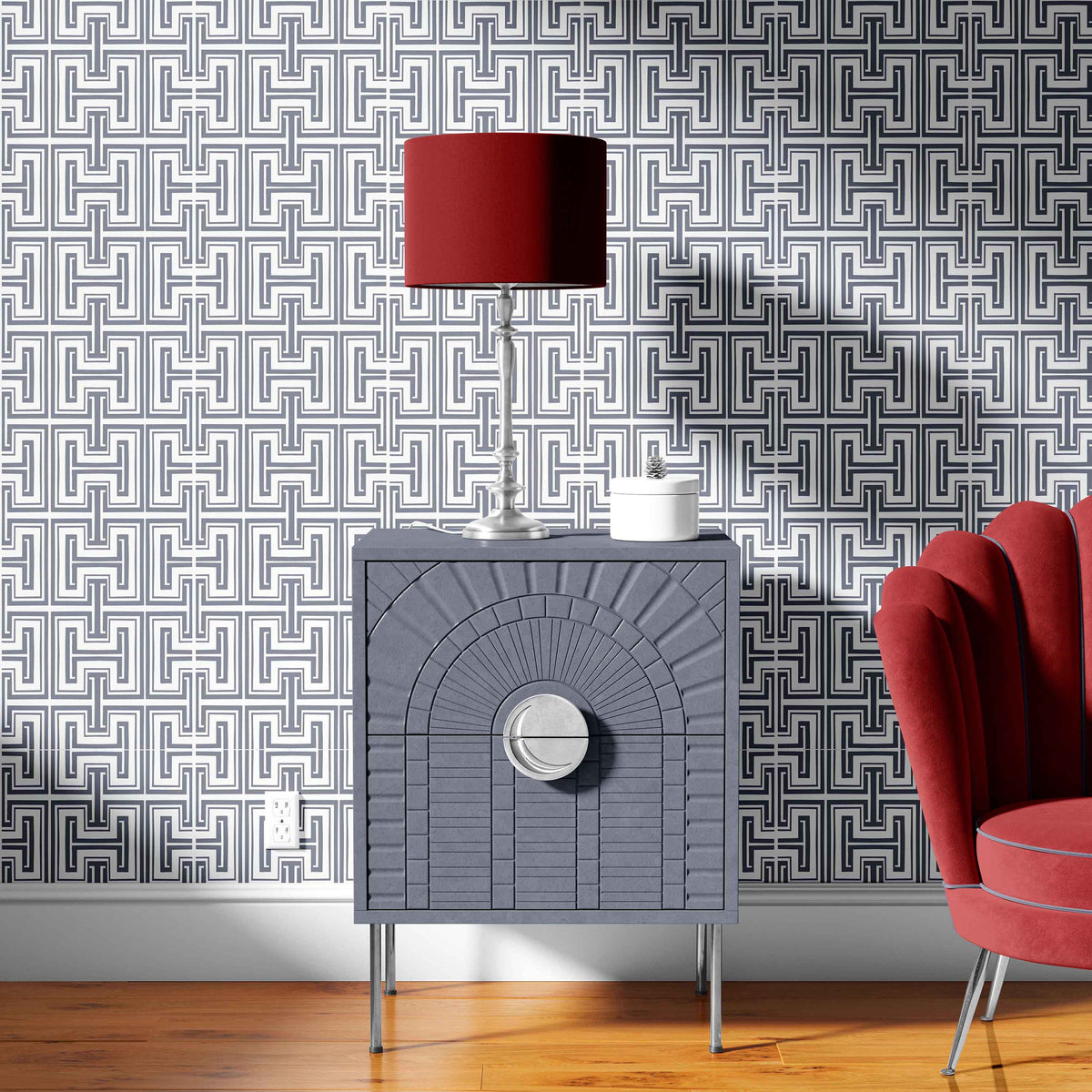 grey_Grey textured side table with red lamp and pink chair against geometric patterned wallpaper