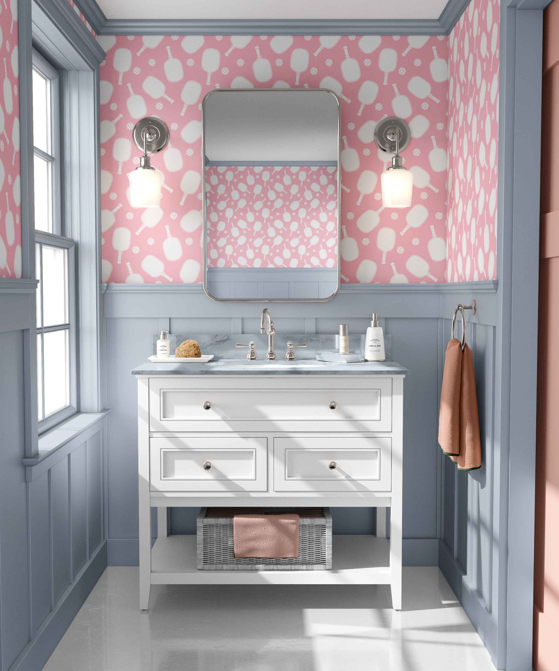 pink_Pickleball paddles in white on a pink background in a bathroom with blue wood panels and white vanity