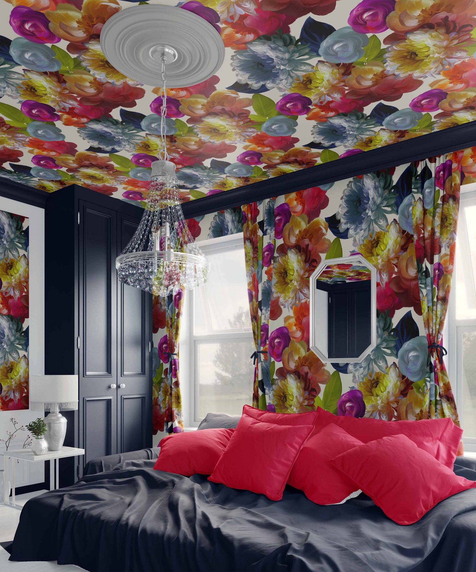 dame_Vibrant painterly floral pattern featuring lush, expressive blossoms in bright shades of pink, coral, yellow, blue, and white with fresh green leaves, creating a rich, layered, and artistic garden-inspired design in a bedroom with a navy bed.