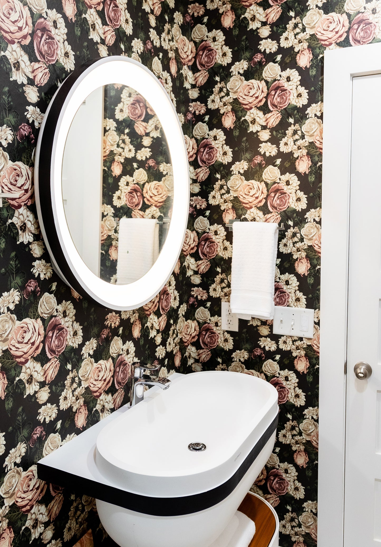 black_floral wallpaper featuring dusty rose colored roses and other flowers on a black background.