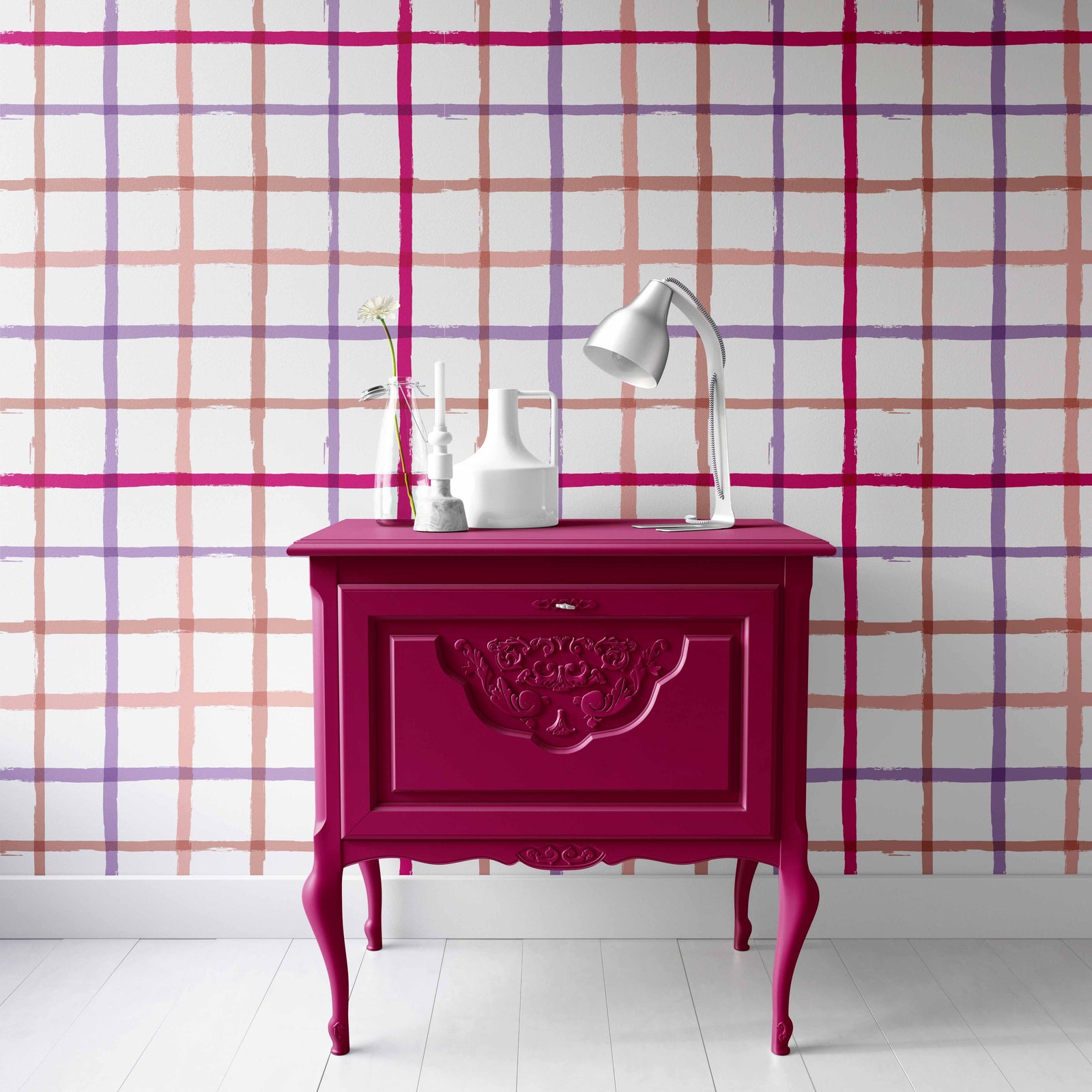 coral_A colorful geometric patterned wallpaper featuring lines in pink, purple, and coral on a white background in a room with a pink nightstand.