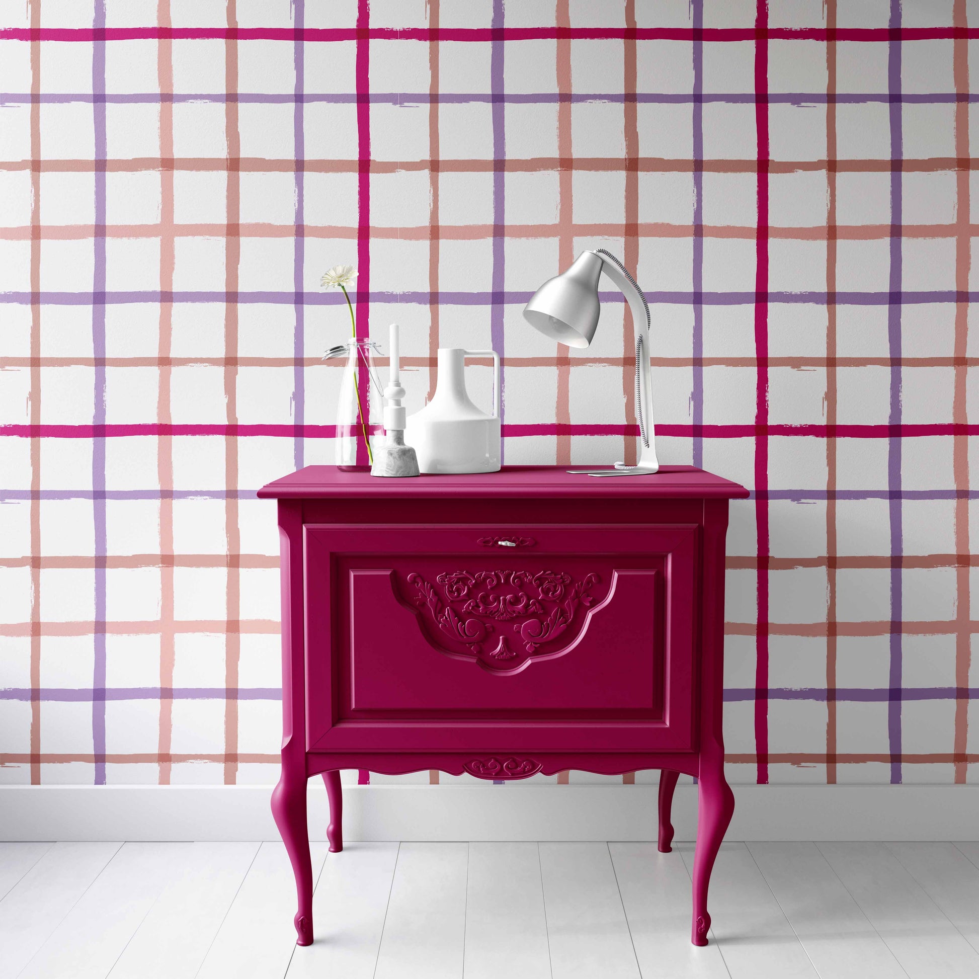 coral_A colorful geometric patterned wallpaper featuring lines in pink, purple, and coral on a white background in a room with a pink nightstand.