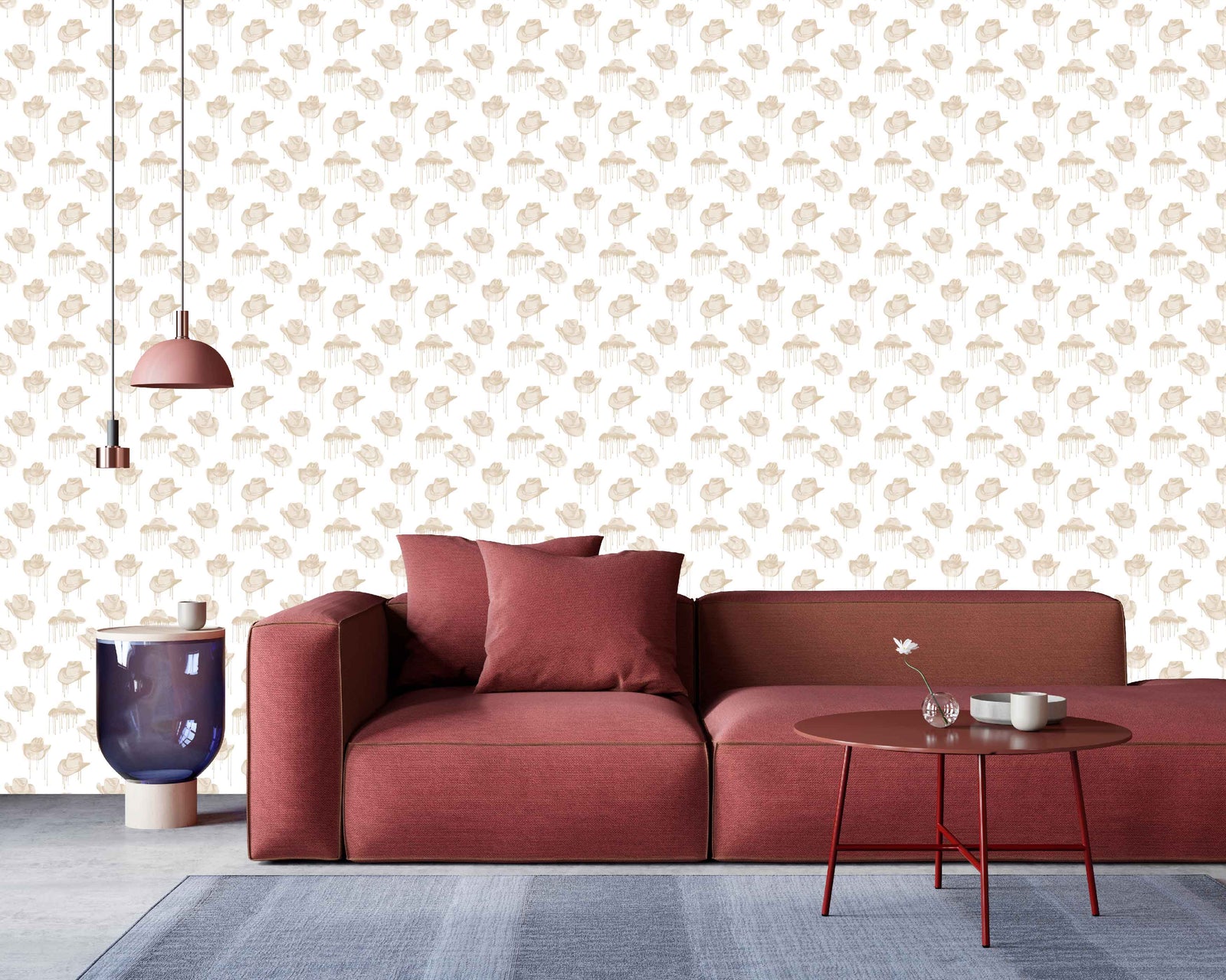 brown_A wallpaper with a pattern of brown cowboy hats with a dripping effect against a white background in a living room with a red couch.