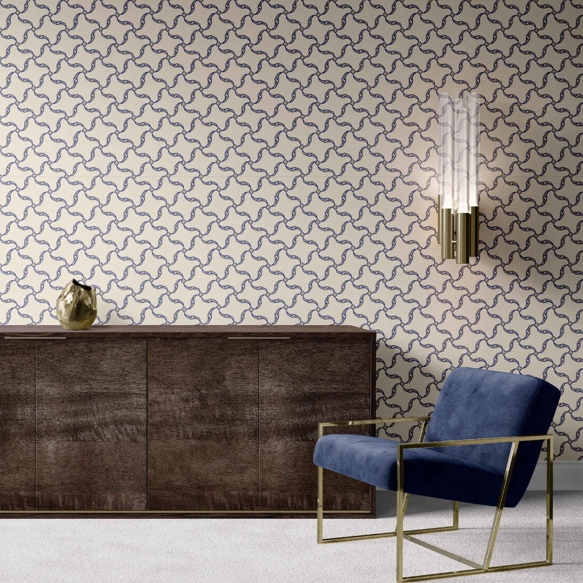 navy_A section of wallpaper with a geometric pattern featuring swirls and floral-like designs, predominantly in navy tones on an off white background in a room with a blue chair and wood dresser. 