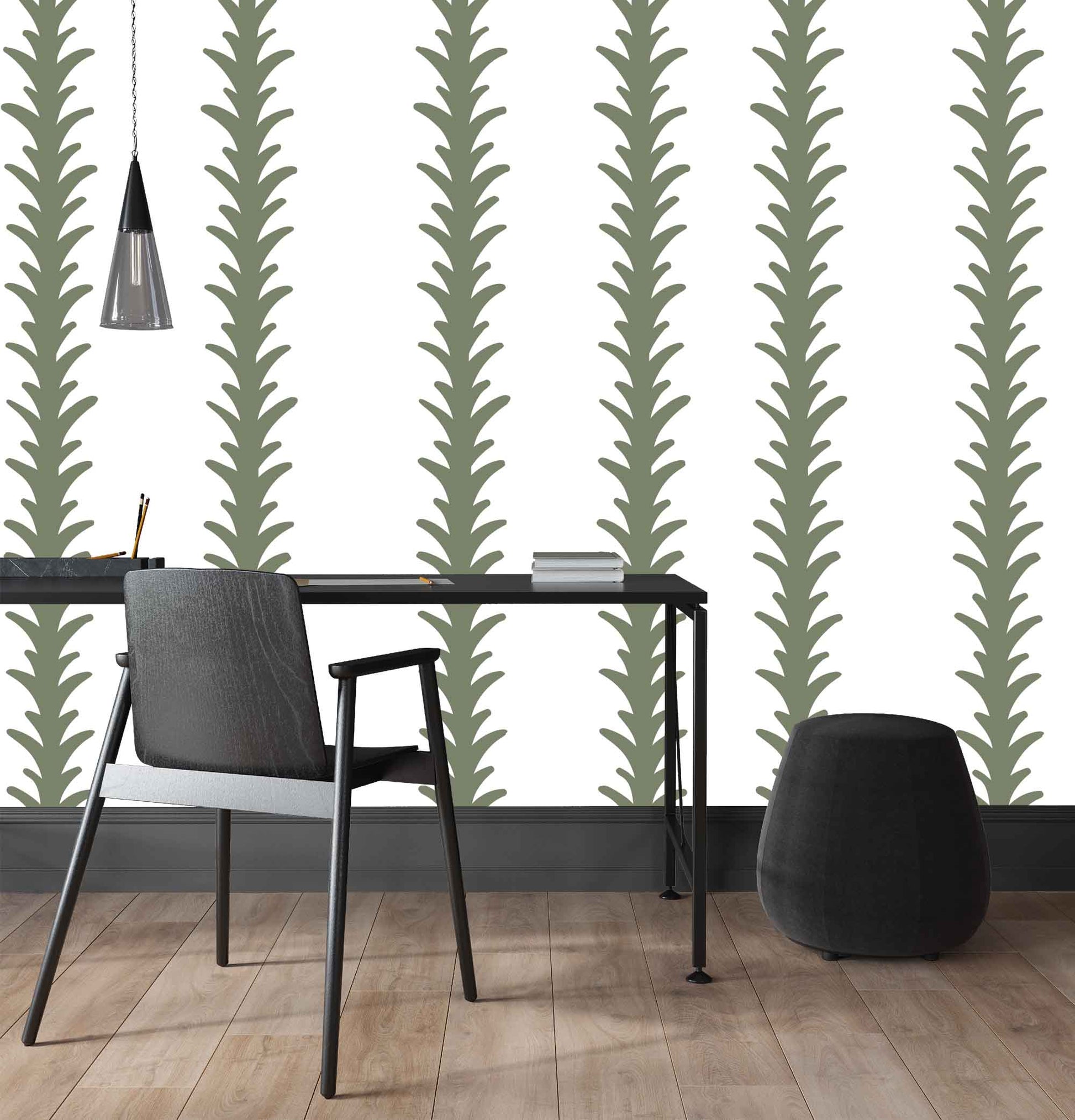 sage_A vertical pattern of leaf-like shapes in shades of sage with a white background, indicative of traditional wallpaper in a room with a desk.